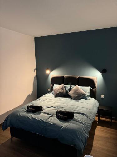 a bedroom with a large bed with two hats on it at Modern Studio in Central Victoria in Victoria