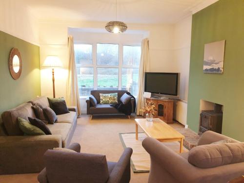 a living room with two couches and a television at Beach House, Llanddulas near Colwyn Bay in Llanddulas