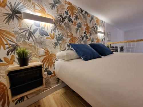 a bedroom with a bed with a tv on it at Mediodia Chica apartamento tipo loft en La Latina in Madrid