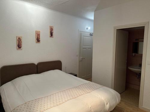 a bedroom with a bed and a bathroom with a sink at Au Wachtfels in Obersteinbach