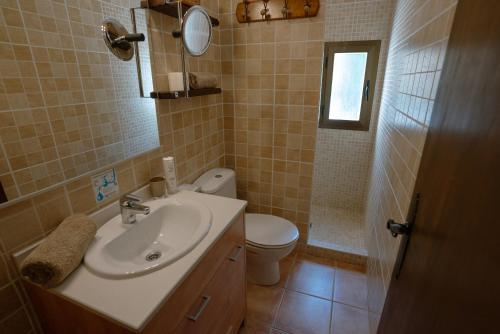 a bathroom with a sink and a toilet at Casa Rural Can Blaiet in La Mola