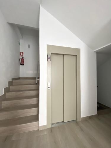 an empty hallway with a door and stairs at Casa Antonio - apartamento Orion in Playa de San Juan