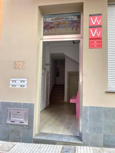 an open door to a hallway with a pink table at Casa Antonio - apartamento Orion in Playa de San Juan