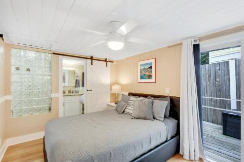 a bedroom with a bed and a window at Mike's Place in Saint Simons Island
