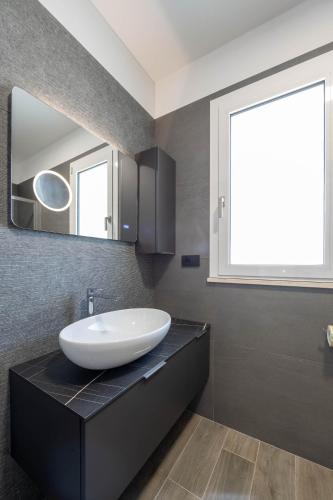 a bathroom with a sink and a mirror at Residence LeoMare in Martinsicuro
