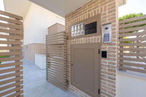 a brick wall with a door in a house at Residence LeoMare in Martinsicuro