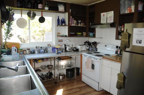 a kitchen with a sink and a stove top oven at Base Camp Anchorage Hostel in Anchorage