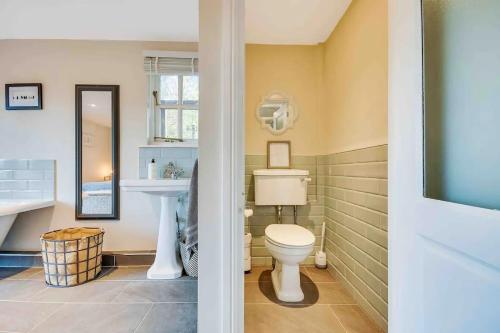 a bathroom with a toilet and a sink at Home sweet home in Little Wymondley