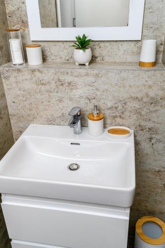 a white sink in a bathroom with a mirror at Divcibare Vrh 26 in Divčibare