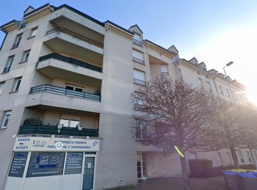 a building with a sign in front of it at Bail Mobilité Résidence Foch Saint-Louis in Poissy