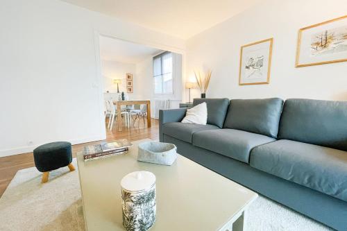 un salon avec un canapé bleu et une table dans l'établissement #GI Watercolours of Clémenceau In front of park Paul Mistral, à Grenoble