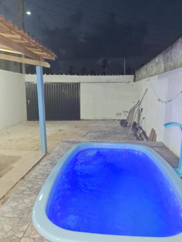 - un bain à remous bleu dans l'arrière-cour la nuit dans l'établissement Casa temporada Barra de Jequia-Al, à Jequiá da Praia