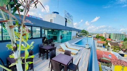 a balcony of a building with a swimming pool at Ocean Porto Flats in Porto De Galinhas