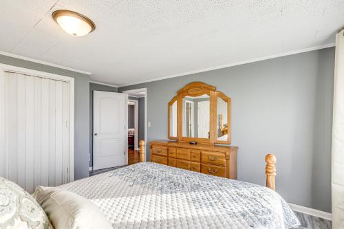 a bedroom with a bed and a dresser and a mirror at Pet-Friendly Union Home about 19 Mi to Cincinnati! in Union