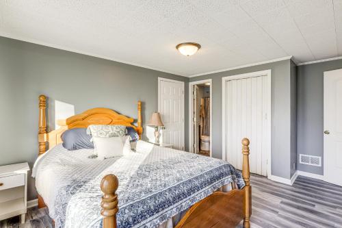 a bedroom with a bed with a blue comforter at Pet-Friendly Union Home about 19 Mi to Cincinnati! in Union