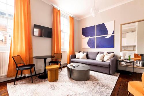 a living room with a couch and a table at Stylish central London flat in London