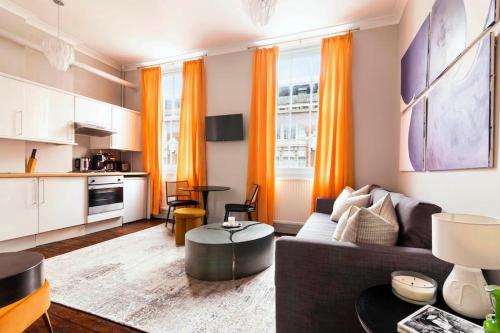 a living room with a couch and a table at Stylish central London flat in London