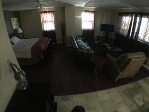 a living room with a bed and a couch at Austin Motor Inn in Austin