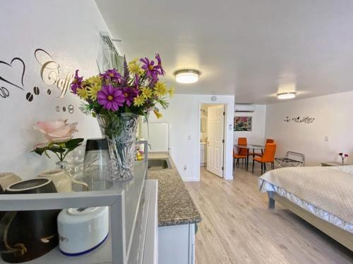 a kitchen with a vase of flowers on a counter at Sun Cabin #2 Pahrump in Pahrump