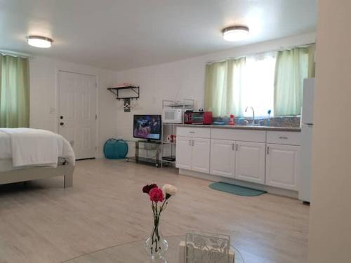 a living room with a vase of flowers on a table at Sun Cabin #2 Pahrump in Pahrump