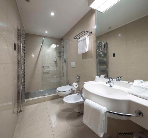 a bathroom with a sink and a toilet and a shower at Best Western Hotel Biri in Padova