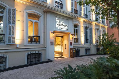 a building with a sign on the front of it at Hôtel Apollinaire Nice in Nice