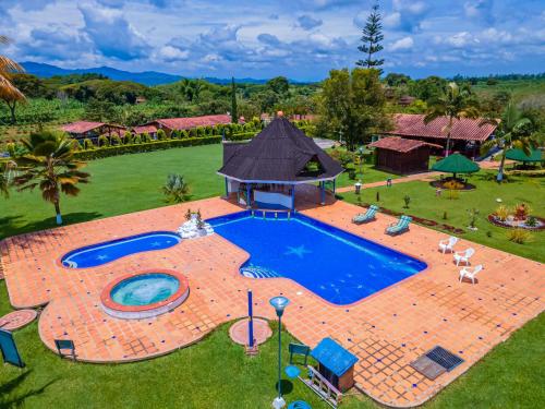 an overhead view of a large swimming pool in a yard at Finca Hotel El Ocaso in Quimbaya