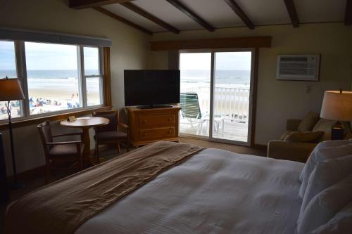 a bedroom with a bed and a view of the beach at Norseman Resort on the Beach in Ogunquit