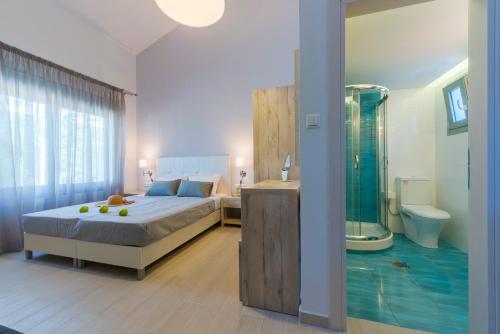 a bedroom with a bed and a bathroom with a shower at Terra di Olive Thassos in Potos