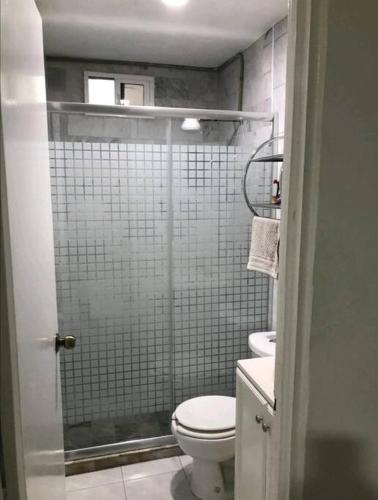 a small bathroom with a toilet and a shower at 302 Excelente apto muy Cerca de Playa in Mazatlán