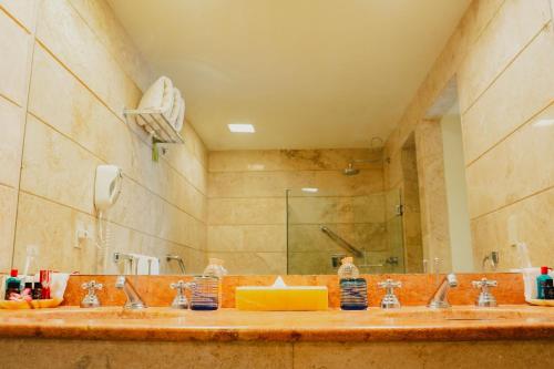 a bathroom with two sinks and a large mirror at Camino Real Zaashila Huatulco in Santa Cruz Huatulco
