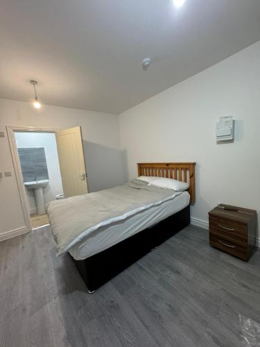 a bedroom with a bed and a dresser in it at Vic Vic property in Oldham