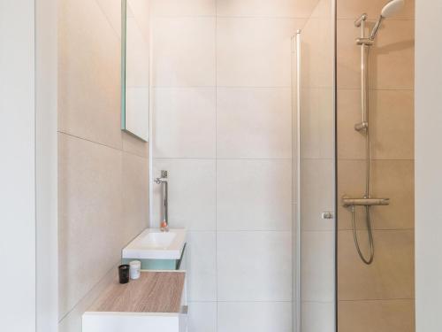 a bathroom with a sink and a shower at Vacation home 450 m from the beach in Katwijk aan Zee