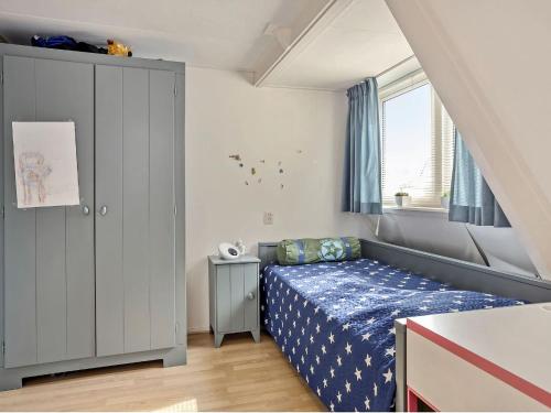 a small bedroom with a bed and a window at Holiday home with a garden and parking in Drachten