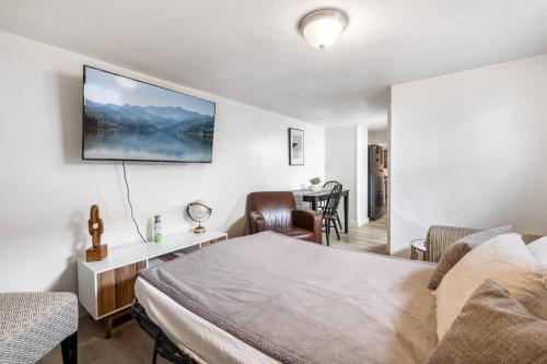 a bedroom with a bed and a table with chairs at Hot Tub Haven+.4 mi. USU East+1G in Price