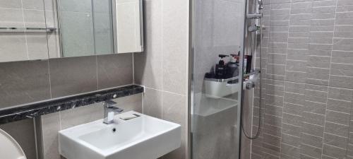 a bathroom with a sink and a shower at Gangneung Sacheon beach Happy House in Gangneung