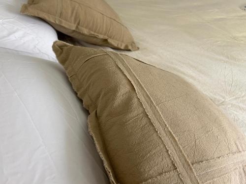 a close up of a bed with a pillow at Imōto estadía en el corazón de Chacras de Coria in Chacras de Coria