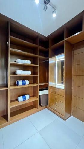 a kitchen with wooden cabinets and towels in a room at LUXURY CONDO BEACHFRONT AMARA in Cancún