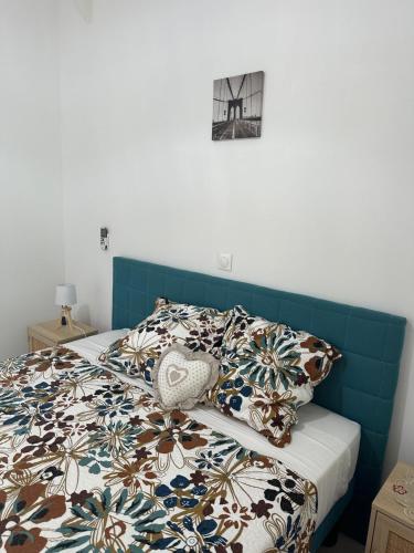 Schlafzimmer mit einem Bett mit blauem Kopfteil in der Unterkunft Bungalow Ixora in Les Abymes