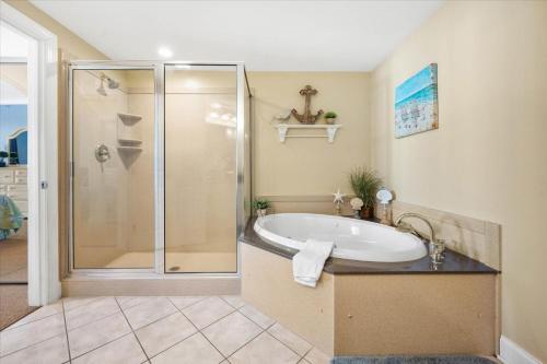 a bathroom with a tub and a shower at 3 BR Belmont Towers on Boardwalk: Ocean & Bay Views in Ocean City