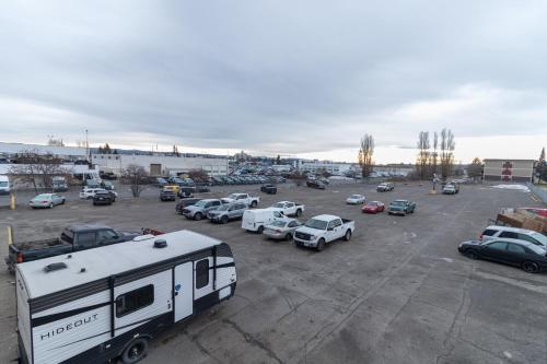 an rv parked in a parking lot with parked cars at Super 8 by Wyndham Prince George in Prince George