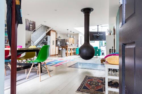 a living room with a dining table and a stove at Urban Farmhouse Flair - Surry Hills Terrace Serenity in Sydney