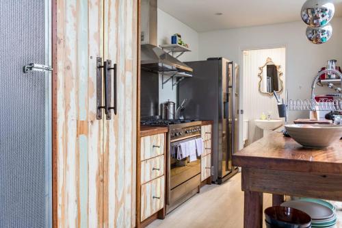 a kitchen with wooden cabinets and a counter top at Urban Farmhouse Flair - Surry Hills Terrace Serenity in Sydney