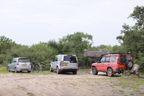 a group of three vehicles parked on a dirt road at The Backwaters Lodge in Wilpattu