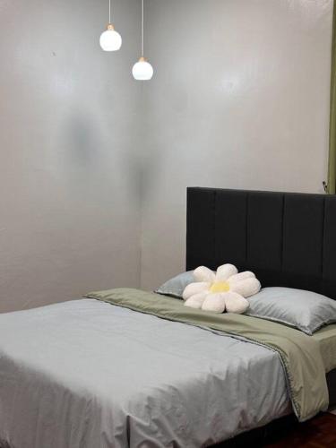 a bed with two white towels on top of it at The Hidden 7 in Taiping