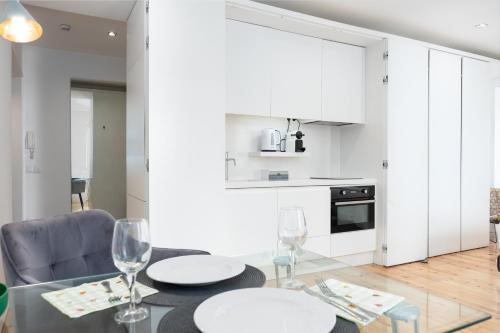 a kitchen and dining room with a table and chairs at Boutique Apartment in the Heart of Lisbon ! Lemonn B in Lisbon