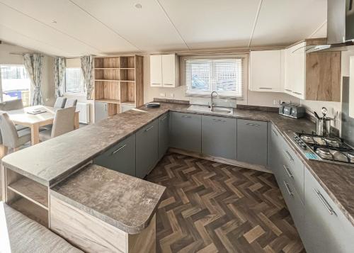 a kitchen with a sink and a counter top at Shear Barn Holiday Park in Hastings