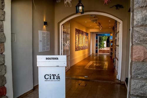 an entrance to a building with a sign in a hallway at Casa de Arte CiTá, bed and breakfasts in San Miguel de Tucumán