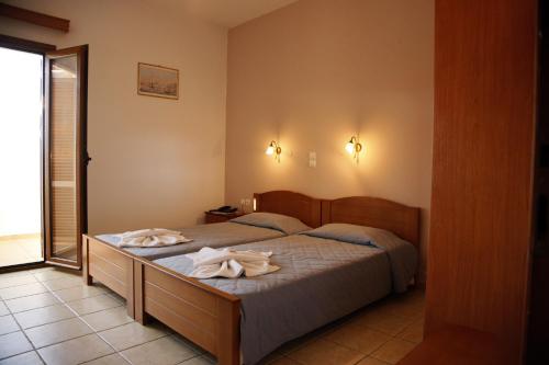 a bedroom with a bed with towels on it at Kalliopi Hotel in Kastéllion