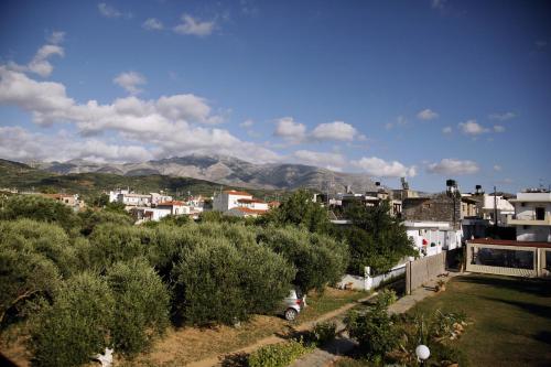 a city with houses and trees and mountains in the background at Kalliopi Hotel in Kastéllion